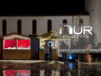 Umbrellas adorn the festive scene in Starnberg, Bavaria, Germany, on December 7, 2024, as the Christmas market embraces the charm of a rainy...