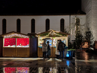 Umbrellas adorn the festive scene in Starnberg, Bavaria, Germany, on December 7, 2024, as the Christmas market embraces the charm of a rainy...