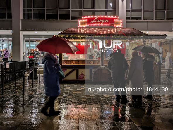 Umbrellas adorn the festive scene in Starnberg, Bavaria, Germany, on December 7, 2024, as the Christmas market embraces the charm of a rainy...