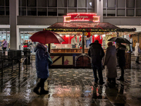 Umbrellas adorn the festive scene in Starnberg, Bavaria, Germany, on December 7, 2024, as the Christmas market embraces the charm of a rainy...