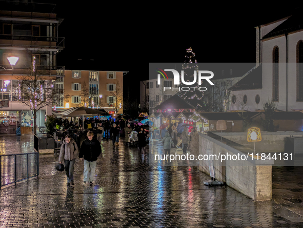 Umbrellas adorn the festive scene in Starnberg, Bavaria, Germany, on December 7, 2024, as the Christmas market embraces the charm of a rainy...