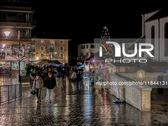 Umbrellas adorn the festive scene in Starnberg, Bavaria, Germany, on December 7, 2024, as the Christmas market embraces the charm of a rainy...