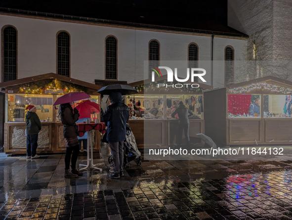 Umbrellas adorn the festive scene in Starnberg, Bavaria, Germany, on December 7, 2024, as the Christmas market embraces the charm of a rainy...