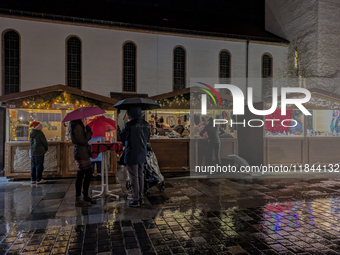 Umbrellas adorn the festive scene in Starnberg, Bavaria, Germany, on December 7, 2024, as the Christmas market embraces the charm of a rainy...