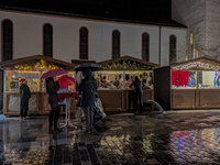 Umbrellas adorn the festive scene in Starnberg, Bavaria, Germany, on December 7, 2024, as the Christmas market embraces the charm of a rainy...