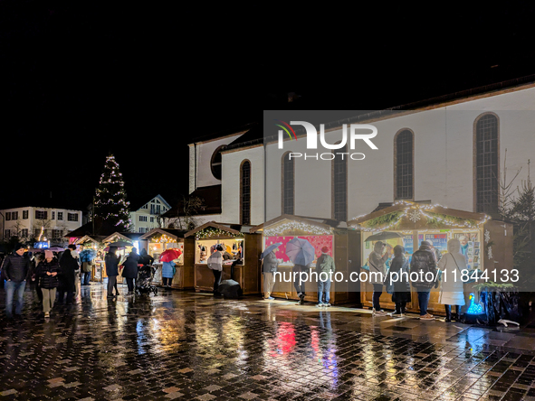 Umbrellas adorn the festive scene in Starnberg, Bavaria, Germany, on December 7, 2024, as the Christmas market embraces the charm of a rainy...