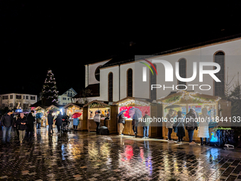 Umbrellas adorn the festive scene in Starnberg, Bavaria, Germany, on December 7, 2024, as the Christmas market embraces the charm of a rainy...