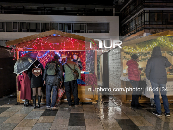 Umbrellas adorn the festive scene in Starnberg, Bavaria, Germany, on December 7, 2024, as the Christmas market embraces the charm of a rainy...