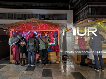 Umbrellas adorn the festive scene in Starnberg, Bavaria, Germany, on December 7, 2024, as the Christmas market embraces the charm of a rainy...