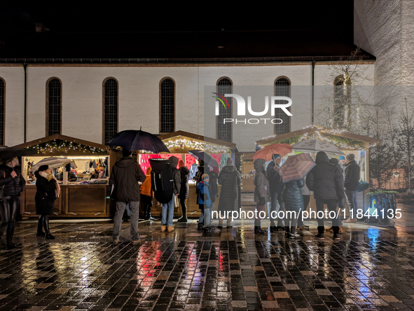 Umbrellas adorn the festive scene in Starnberg, Bavaria, Germany, on December 7, 2024, as the Christmas market embraces the charm of a rainy...