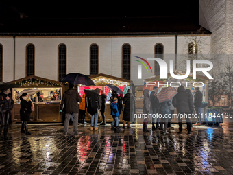 Umbrellas adorn the festive scene in Starnberg, Bavaria, Germany, on December 7, 2024, as the Christmas market embraces the charm of a rainy...