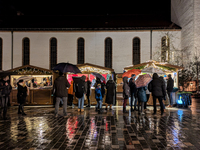 Umbrellas adorn the festive scene in Starnberg, Bavaria, Germany, on December 7, 2024, as the Christmas market embraces the charm of a rainy...