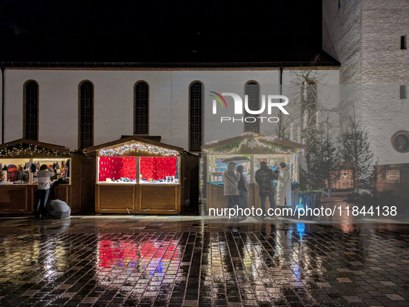 Umbrellas adorn the festive scene in Starnberg, Bavaria, Germany, on December 7, 2024, as the Christmas market embraces the charm of a rainy...