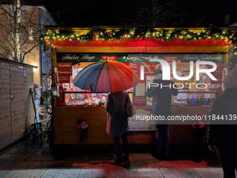 Umbrellas adorn the festive scene in Starnberg, Bavaria, Germany, on December 7, 2024, as the Christmas market embraces the charm of a rainy...