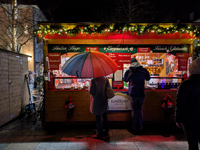 Umbrellas adorn the festive scene in Starnberg, Bavaria, Germany, on December 7, 2024, as the Christmas market embraces the charm of a rainy...