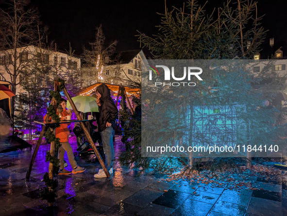 Umbrellas adorn the festive scene in Starnberg, Bavaria, Germany, on December 7, 2024, as the Christmas market embraces the charm of a rainy...