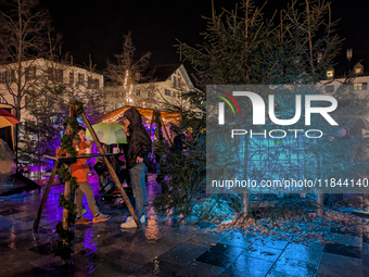 Umbrellas adorn the festive scene in Starnberg, Bavaria, Germany, on December 7, 2024, as the Christmas market embraces the charm of a rainy...