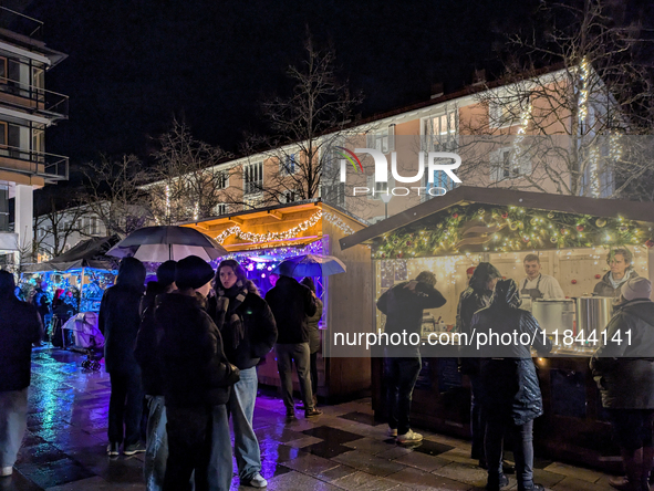 Umbrellas adorn the festive scene in Starnberg, Bavaria, Germany, on December 7, 2024, as the Christmas market embraces the charm of a rainy...