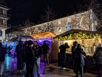 Umbrellas adorn the festive scene in Starnberg, Bavaria, Germany, on December 7, 2024, as the Christmas market embraces the charm of a rainy...