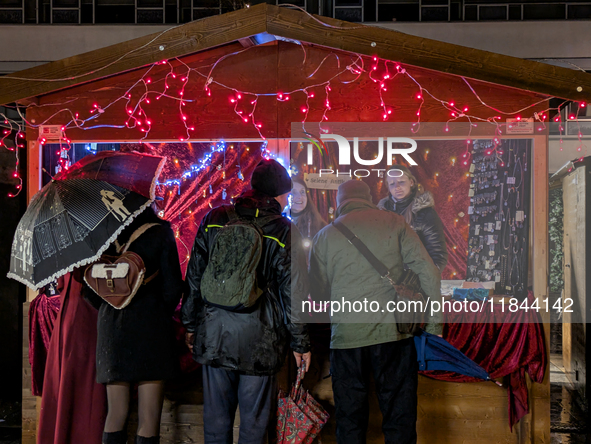 Umbrellas adorn the festive scene in Starnberg, Bavaria, Germany, on December 7, 2024, as the Christmas market embraces the charm of a rainy...