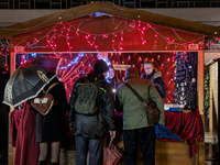 Umbrellas adorn the festive scene in Starnberg, Bavaria, Germany, on December 7, 2024, as the Christmas market embraces the charm of a rainy...