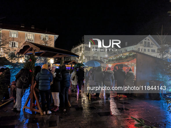 Umbrellas adorn the festive scene in Starnberg, Bavaria, Germany, on December 7, 2024, as the Christmas market embraces the charm of a rainy...