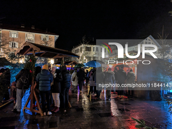 Umbrellas adorn the festive scene in Starnberg, Bavaria, Germany, on December 7, 2024, as the Christmas market embraces the charm of a rainy...