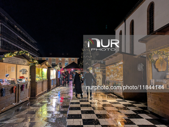 Umbrellas adorn the festive scene in Starnberg, Bavaria, Germany, on December 7, 2024, as the Christmas market embraces the charm of a rainy...