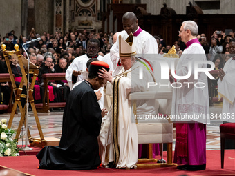 Pope Francis places the biretta upon the head of newly appointed Indian cardinal Jacob Koovakad during an Ordinary Public Consistory for the...