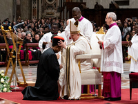 Pope Francis places the biretta upon the head of newly appointed Indian cardinal Jacob Koovakad during an Ordinary Public Consistory for the...