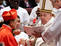 Philippine Cardinal Pablo Virgilio Siongco David (L) receives his biretta as he is appointed cardinal by Pope Francis (R) during a consistor...