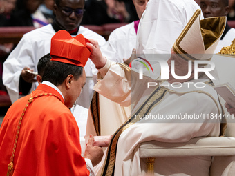 Philippine Cardinal Pablo Virgilio Siongco David (L) receives his biretta as he is appointed cardinal by Pope Francis (R) during a consistor...