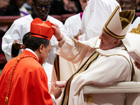 Philippine Cardinal Pablo Virgilio Siongco David (L) receives his biretta as he is appointed cardinal by Pope Francis (R) during a consistor...