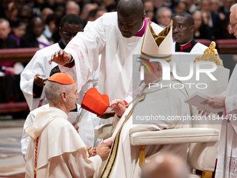 Newly-appointed Franco-Algerian Cardinal Jean-Paul Vesco (L) looks on during an Ordinary Public Consistory for the creation of new cardinals...