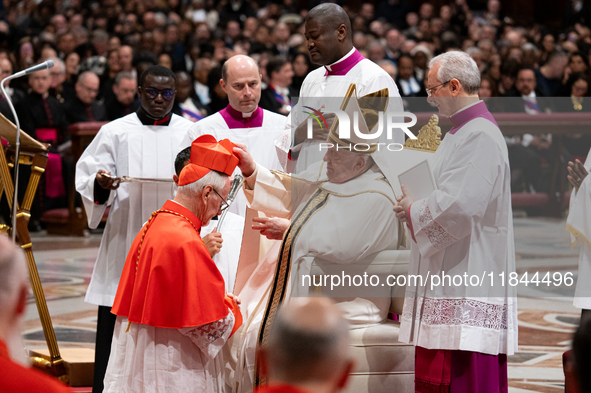 Pope Francis places the biretta upon the head of newly appointed Argentina cardinal Vicente Bokalic Iglic during an Ordinary Public Consisto...