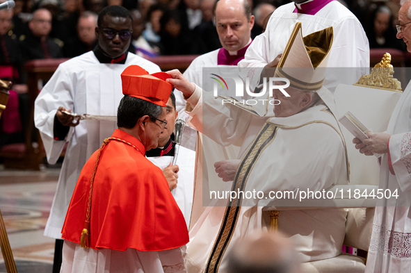 Pope Francis places the biretta upon the head of newly appointed Equatorian Cardinal Luis Gerardo Cabrera Herrera during an Ordinary Public...