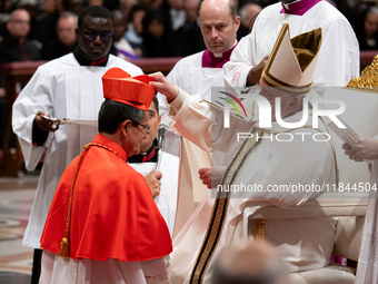 Pope Francis places the biretta upon the head of newly appointed Equatorian Cardinal Luis Gerardo Cabrera Herrera during an Ordinary Public...