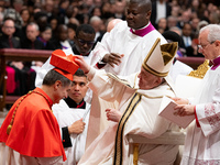 Roberto Repole, Archbishop of Turin and Bishop of Susa, Italy, right, receives the cardinals' biretta hat and ring from Pope Francis, left,...