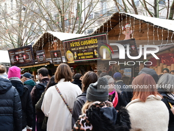 People are at the Christmas market on Place Carnot in Lyon, France, on December 7, 2024. (