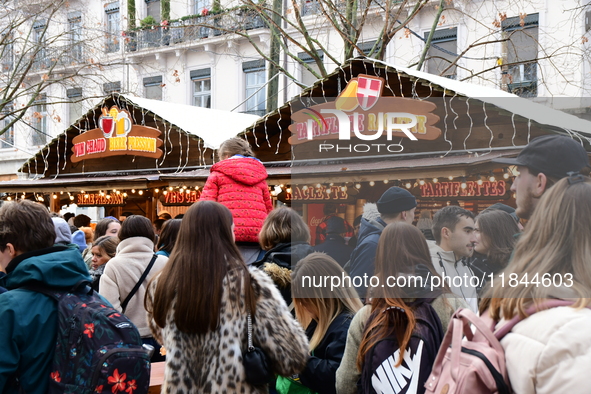 People are at the Christmas market on Place Carnot in Lyon, France, on December 7, 2024. 