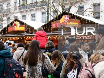 People are at the Christmas market on Place Carnot in Lyon, France, on December 7, 2024. (