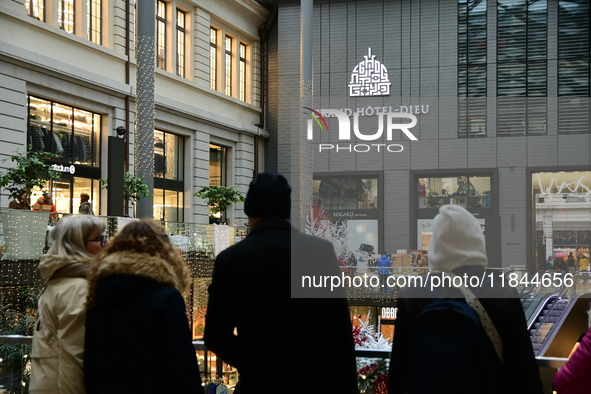 Several people attend the creators market at the Grand Hotel Dieu in Lyon, France, on December 7, 2024. 