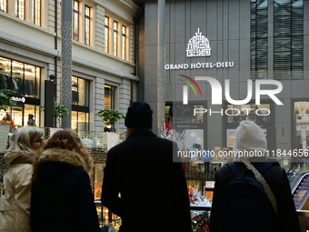 Several people attend the creators market at the Grand Hotel Dieu in Lyon, France, on December 7, 2024. (