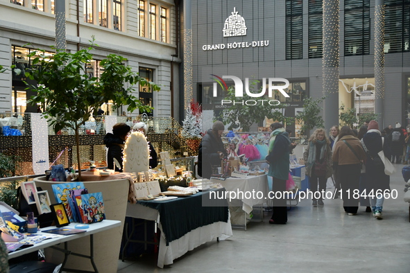 Several people attend the creators market at the Grand Hotel Dieu in Lyon, France, on December 7, 2024. 