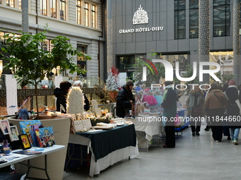 Several people attend the creators market at the Grand Hotel Dieu in Lyon, France, on December 7, 2024. (