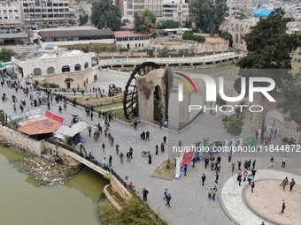 Celebrations continue in the city of Hama, where Syrians gather at Al-Assi Square to take commemorative photos and express their joy over th...