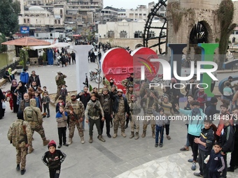 Celebrations continue in the city of Hama, where Syrians gather at Al-Assi Square to take commemorative photos and express their joy over th...