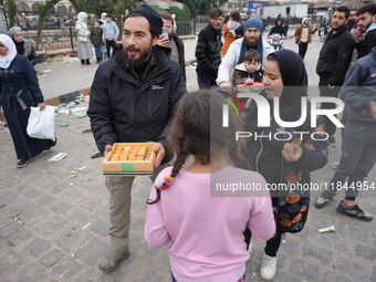 Celebrations continue in the city of Hama, where Syrians gather at Al-Assi Square to take commemorative photos and express their joy over th...