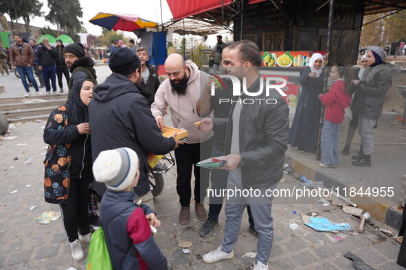 Celebrations continue in the city of Hama, where Syrians gather at Al-Assi Square to take commemorative photos and express their joy over th...