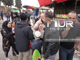 Celebrations continue in the city of Hama, where Syrians gather at Al-Assi Square to take commemorative photos and express their joy over th...